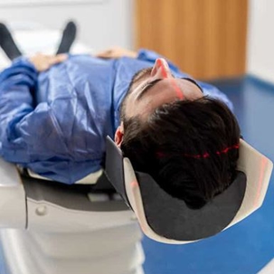 Man goes into an MRI machine for a brain scan after a traumatic brain injury